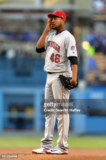 Ivan Nova of the Pittsburgh Pirates looks on after allowing a solo home run to Max Muncy of the Los Angeles Dodgers during the first inning of a game...