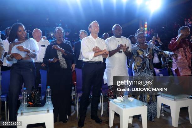 French President Emmanuel Macron and Lagos Governor Akinwunmi Ambode dance at the Afrika Shrine in Lagos on July 3, 2018. - French President Emmanuel...