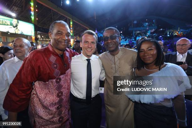 French President Emmanuel Macron poses with Nigerian musician Femi Kuti and Senegalese singer Youssou N'dour at the Afrika Shrine in Lagos on July 3,...