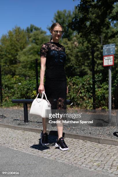 Tabea Ernst is seen attending Maisonee Berlin wearing a black lace dress with Fila shoes during the Berlin Fashion Week July 2018 on July 3, 2018 in...