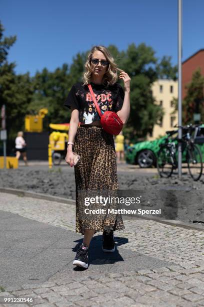 Laura Simon is seen attending Maisonee Berlin wearing an ACDC shirt with animal print skirt and red cross body bag during the Berlin Fashion Week...