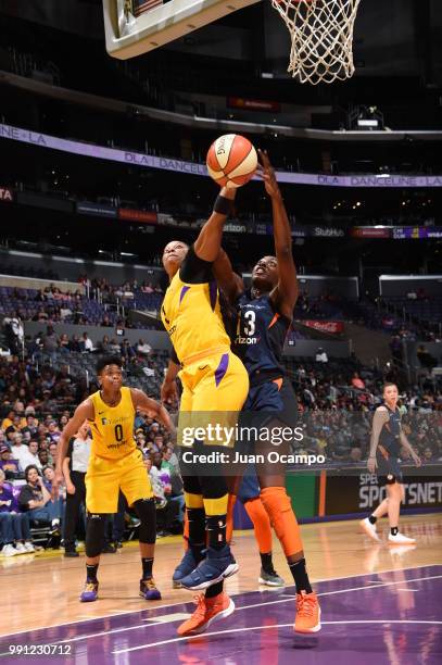 Odyssey Sims of the Los Angeles Sparks and Chiney Ogwumike of the Connecticut Sun compete for the ball on July 3, 2018 at STAPLES Center in Los...