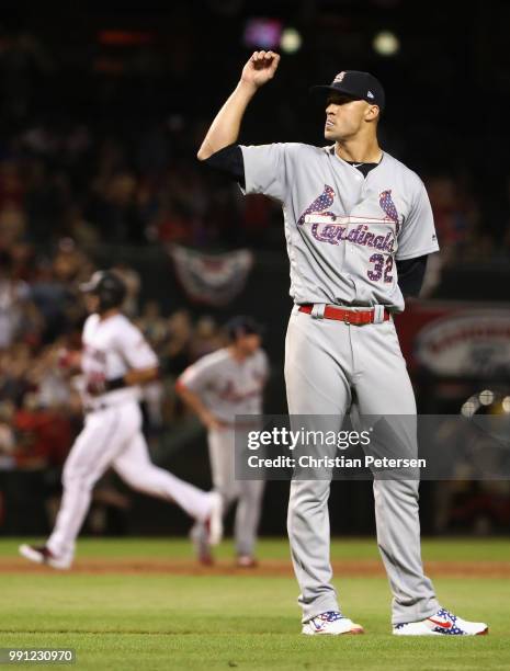 Starting pitcher Jack Flaherty of the St. Louis Cardinals reacts after giving up a three-run home run to Paul Goldschmidt of the Arizona Diamondbacks...