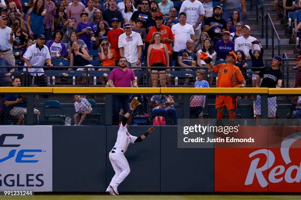 Gerardo Parra of the Colorado Rockies catches a fly ball on the warning track for the second out of the seventh inning against the San Francisco...