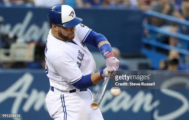 Toronto Blue Jays catcher Russell Martin makes contact as the Toronto Blue Jays beat the New York Mets 8-6 at the Rogers Centre in Toronto. July 3,...