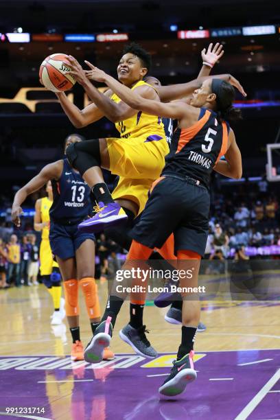 Alana Beard of the Los Angeles Sparks handles the ball against Jasmine Thomas of the Connecticut Sun during a WNBA basketball game at Staples Center...