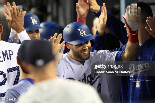 Chris Taylor of the Los Angeles Dodgers is congratulated in the dugout after hitting a two run home run during the fourth inning of a game against...