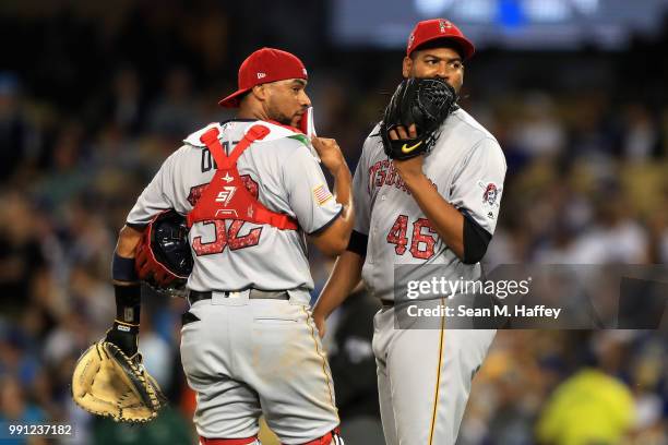 Ivan Nova of the Pittsburgh Pirates talks with catcher Elias Diaz on the mound during the fourth inning of a game against the Los Angeles Dodgers at...