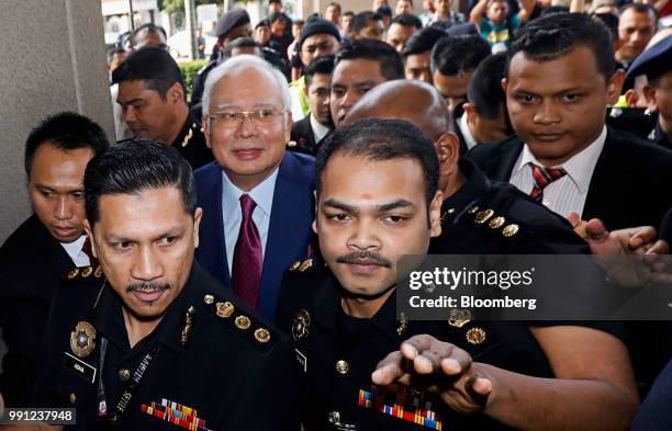 Najib Razak, Malaysia's former prime minister, center left, arrives at the Kuala Lumpur Courts Complex in Kuala Lumpur, Malaysia, on Wednesday, July...