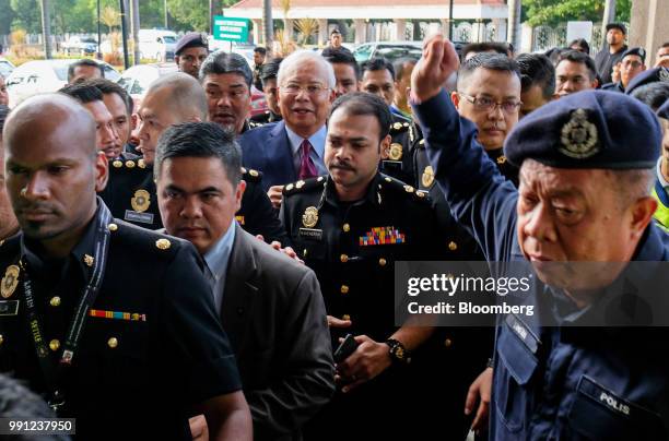 Najib Razak, Malaysia's former prime minister, center, arrives at the Kuala Lumpur Courts Complex in Kuala Lumpur, Malaysia, on Wednesday, July 4,...