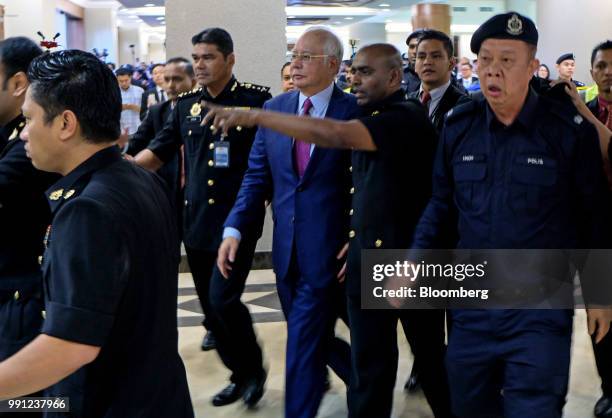 Najib Razak, Malaysia's former prime minister, center left, arrives at the Kuala Lumpur Courts Complex in Kuala Lumpur, Malaysia, on Wednesday, July...