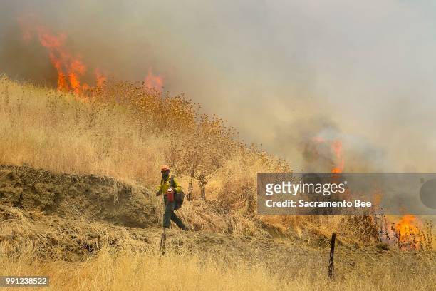 Hot Shot crews from Mendocino, Calif., use backfires to help contain the County fire along Highway 129 near Lake Berryessa in Yolo County, Calif., on...