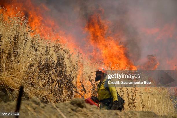 Hot Shot crews from Mendocino, Calif., use backfires to help contain the County fire along Highway 129 near Lake Berryessa in Yolo County, Calif., on...