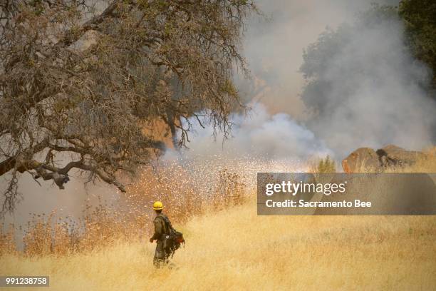 Hot Shot crews from Truckee, Calif., use incendiary devices to start backfires to help contain the County fire along Highway 129, near Lake Berryessa...