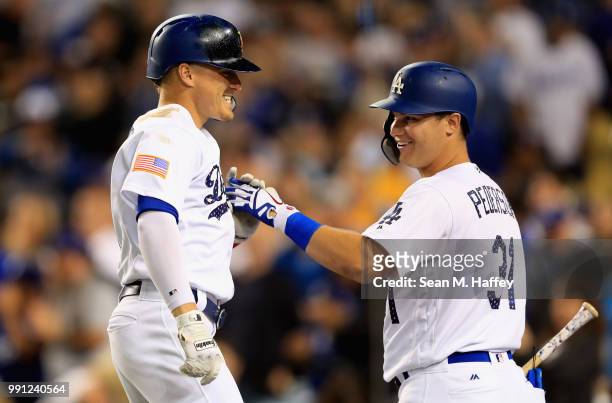 Joc Pederson congratulates Enrique Hernandez of the Los Angeles Dodgers after his two-run homerun during the sixth inning of a game against the...