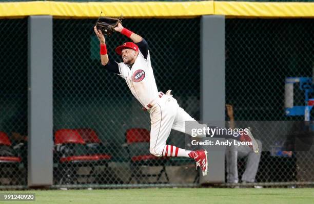 Billy Hamilton of the Cincinnati Reds leaps to catch the ball in the ninth inning against the Chicago White Sox at Great American Ball Park on July...