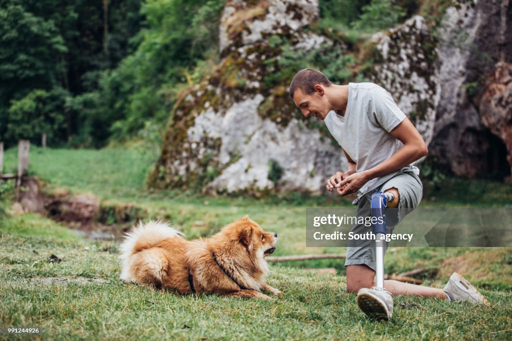 Disability man playing with pet