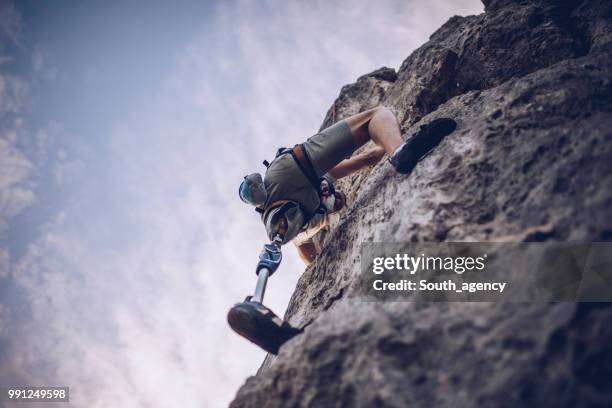 disability guy moving up - rock climbing stock pictures, royalty-free photos & images