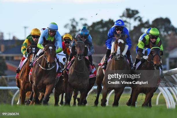 Michael Walker riding Whyouask in yellow cap before making a run to win Race 5 during Melbourne Racing at Sandown Hillside on July 4, 2018 in...