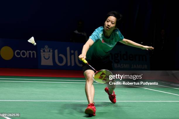 Cheung Ngan Yi of Hong Kong competes against He Bingjiao of China during the Women's Singles Round 1 match on day one of the Blibli Indonesia Open at...