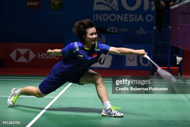 He Bingjiao of China competes against Cheung Ngan Yi of Hong Kong during the Women's Singles Round 1 match on day one of the Blibli Indonesia Open at...
