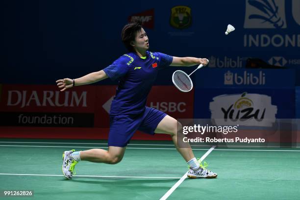 He Bingjiao of China competes against Cheung Ngan Yi of Hong Kong during the Women's Singles Round 1 match on day one of the Blibli Indonesia Open at...