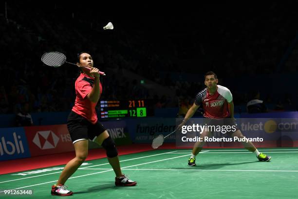 Riky Widianto and Masita Mahmudin of Indonesia compete against Wang Chi-Lin and Lee Chia Hsin of Chinese Taipei during the Mixed Doubles Round 1...