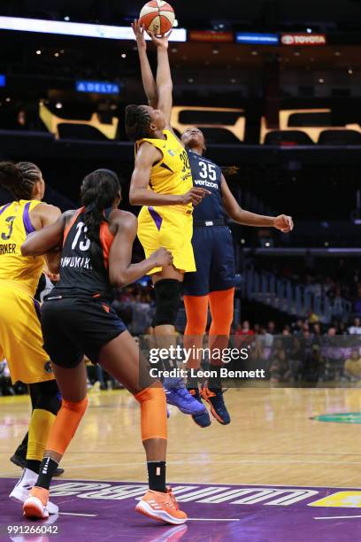 Nneka Ogwumike of the Los Angeles Sparks jumps against Jonquel Jones of the Connecticut Sun during a WNBA basketball game at Staples Center on July...