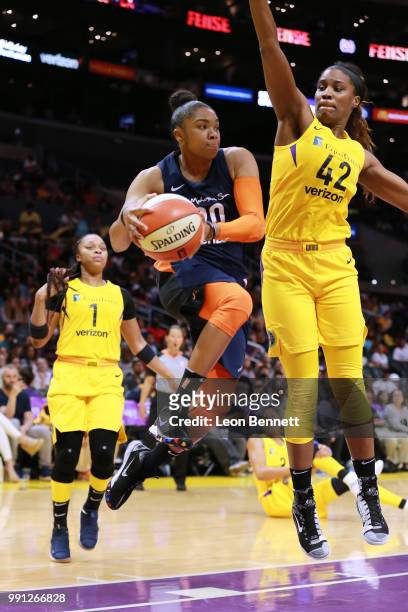 Alex Bentley of the Connecticut Sun handles the ball against Jantel Lavender of the Los Angeles Sparks during a WNBA basketball game at Staples...