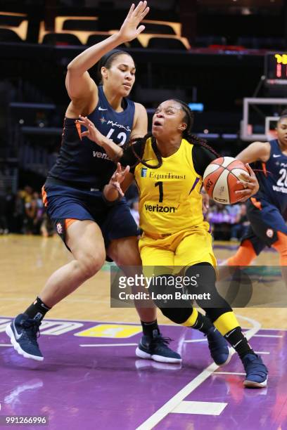 Odyssey Sims of the Los Angeles Sparks handles the ball against Brionna Jones of the Connecticut Sun during a WNBA basketball game at Staples Center...