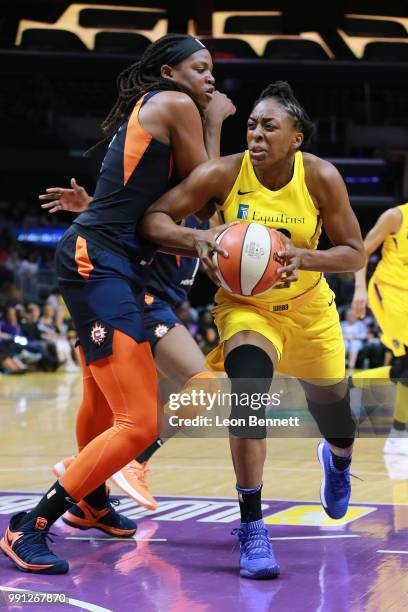 Nneka Ogwumike of the Los Angeles Sparks handles the ball against Jonquel Jones of the Connecticut Sun during a WNBA basketball game at Staples...