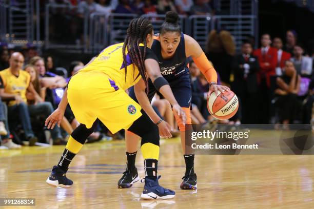 Alex Bentley of the Connecticut Sun handles the ball against Odyssey Sims of the Los Angeles Sparks during a WNBA basketball game at Staples Center...