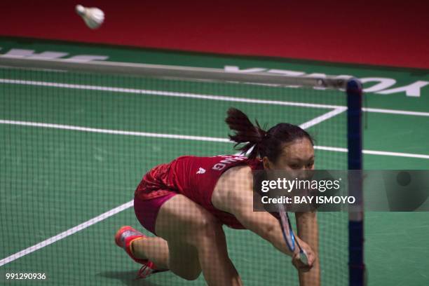 Zhang Beiwen of China hits a return against Aya Ohori of Japan during their women's singles badminton match at the Indonesia Open in Jakarta on July...