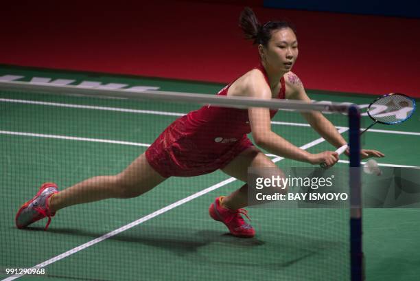 Zhang Beiwen of China hits a return against Aya Ohori of Japan during their women's singles badminton match at the Indonesia Open in Jakarta on July...