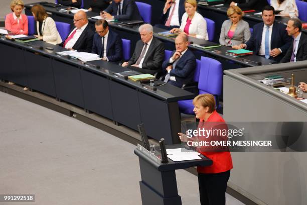 German Chancellor Angela Merkel delivers a speech as German Defence Minister Ursula von der Leyen, Justice Minister Katarina Barley, Economy Minister...