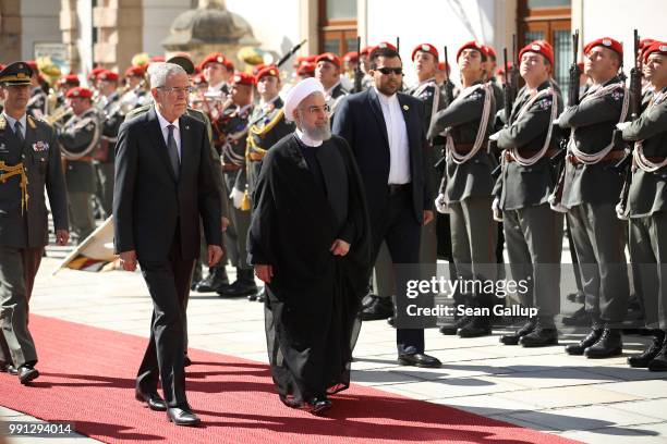 Austrian President Alexander van der Bellen and Iranian President Hassan Rouhani review a guard of honor upon Rouhani's arrival at Hofburg Palace on...