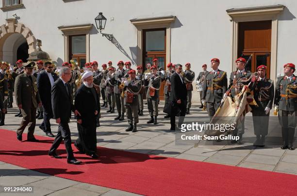 Austrian President Alexander van der Bellen and Iranian President Hassan Rouhani review a guard of honor upon Rouhani's arrival at Hofburg Palace on...