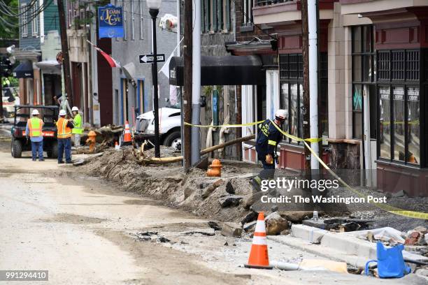 Howard County Special Operations worker checks on businesses on Main Street May 29, 2018 in Ellicott City, MD. This comes two years after another...