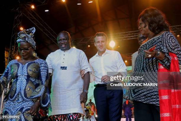 French President Emmanuel Macron dances next to Lagos Governor Akinwunmi Ambode at the Shrine Afrika in Lagos on July 3, 2018. - French President...