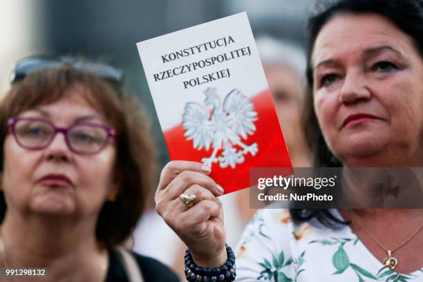 Protestor holds a copy of Polish Constitution during a protest against Supreme Court Reforms in Poland. Krakow, Poland on 3 July, 2018.