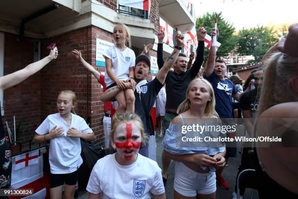 Residents of the Kirby Estate celebrate England scoring from the penalty spot as they watch the FIFA 2018 World Cup Finals match between Colombia and...