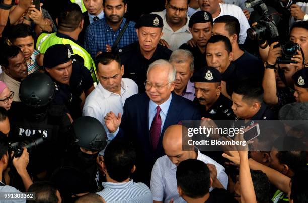 Najib Razak, Malaysia's former prime minister, center, leaves the Kuala Lumpur Courts Complex in Kuala Lumpur, Malaysia, on Wednesday, July 4, 2018....