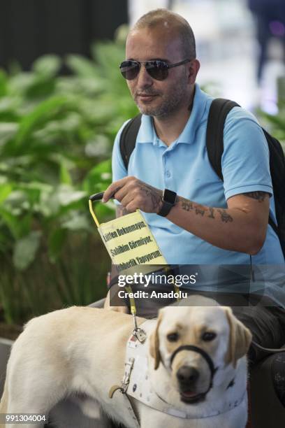 Veteran Gendarmery Sergeant Hasan Arisoy , who lost his sight ability and his right hand after a mine bomb blasted in Cukurca, is seen with his guide...