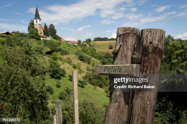 Walking marker points to a local place near Saint Michael's church, on 23rd June 2018, in Celje, Slovenia.