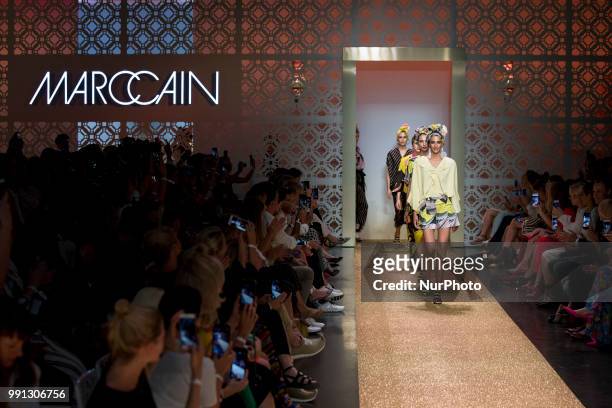 Models run the runway during the Marc Cain Spring/Summer 2019 Fashion Show at Westhafen in Berlin, Germany on July 3, 2018.