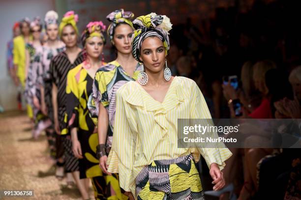 Models run the runway during the Marc Cain Spring/Summer 2019 Fashion Show at Westhafen in Berlin, Germany on July 3, 2018.