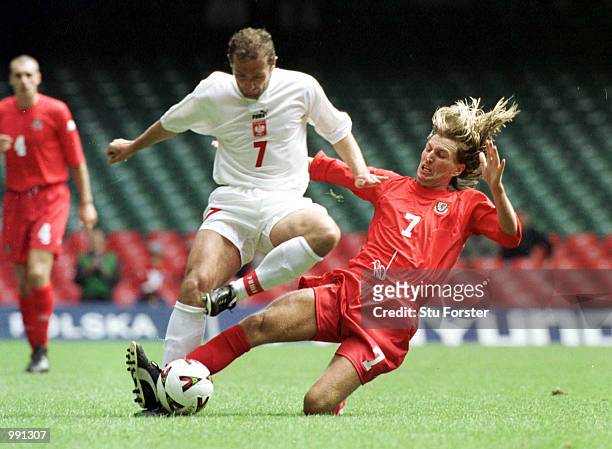 Marek Kozminski of Poland gets past Robbie Savage of Wales during the match between Wales and Poland in the 2002 World Cup Qualifying Group 5 at...