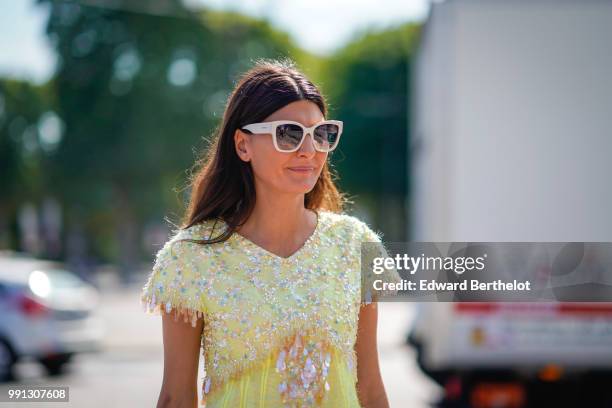 Giovanna Battaglia wears a yellow dress with lace, outside Chanel, during Paris Fashion Week Haute Couture Fall Winter 2018/2019, on July 3, 2018 in...