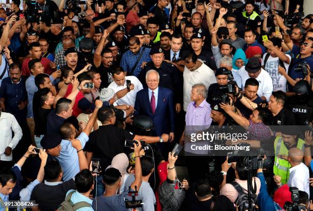 Najib Razak, Malaysia's former prime minister, center, leaves the Kuala Lumpur Courts Complex in Kuala Lumpur, Malaysia, on Wednesday, July 4, 2018....