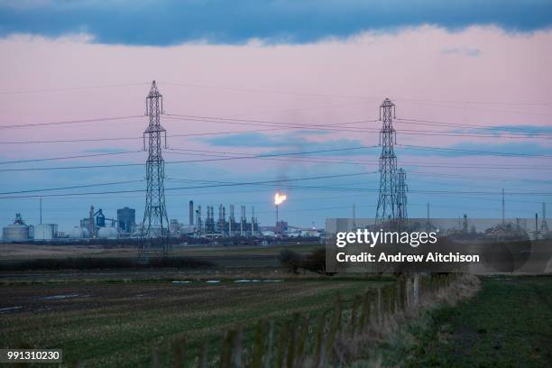 Electrical pylons in front of production tower in flames at the ConocoPhillips Oil Terminal at Seal Sands, Middlesbrough, North Yorkshire, United...